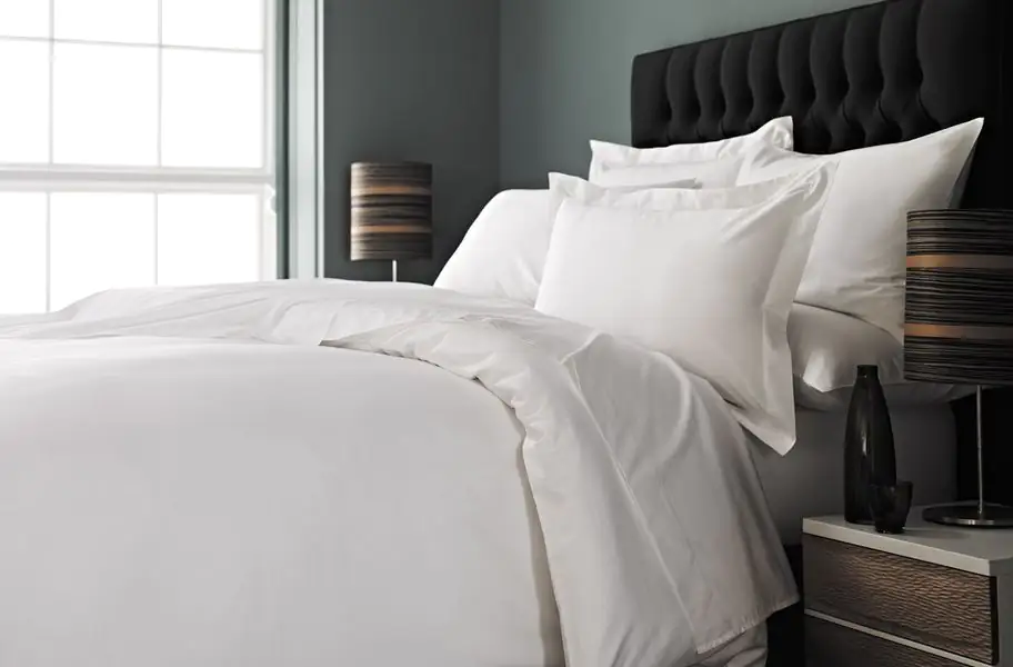 All white bedding with black headboard All white bedding with black headboard