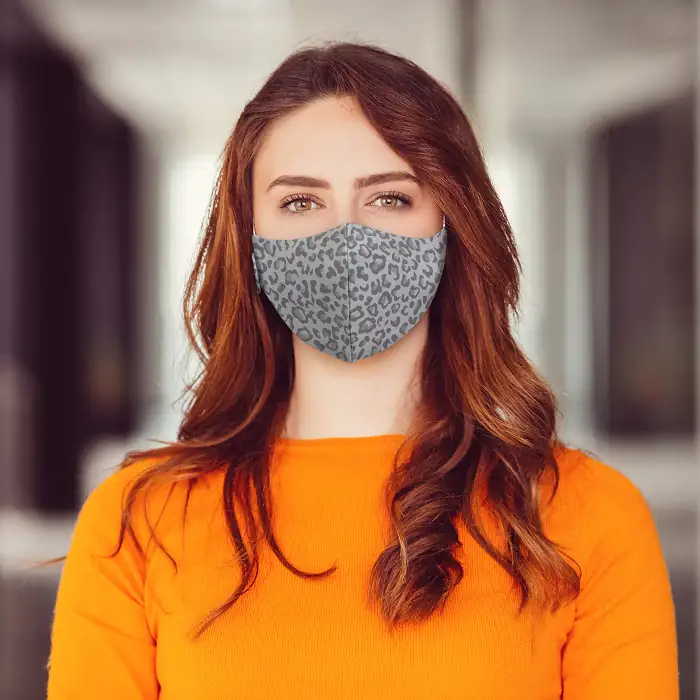 Woman wearing Martex Health leopard print grey coloured reusable face mask with antimicrobial protection.