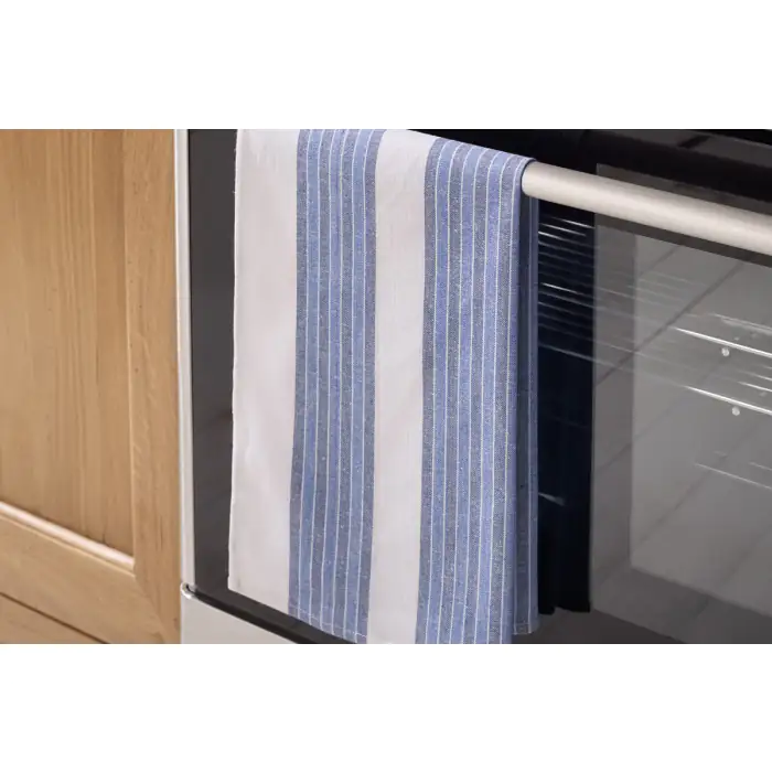 Multi-stripe blue tea towel made from 100% cotton hanging off an oven door