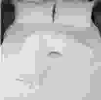 V shaped pillow sitting on bed, with waterproof and flame retardant protection,