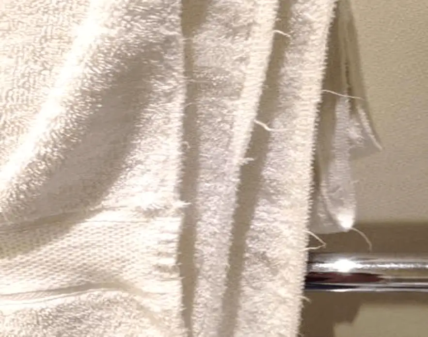 Worn and frayed hems on a towe Worn and frayed hems on a towel